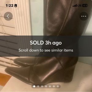 Thigh high black boots with white stitching